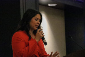 a woman in red speaking into a microphone